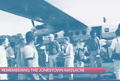 A photo of members of Jonestown standing near a small plane