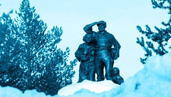 The Donner Party Memorial showing bronze statues of members of the party, standing above a deep snowbank 