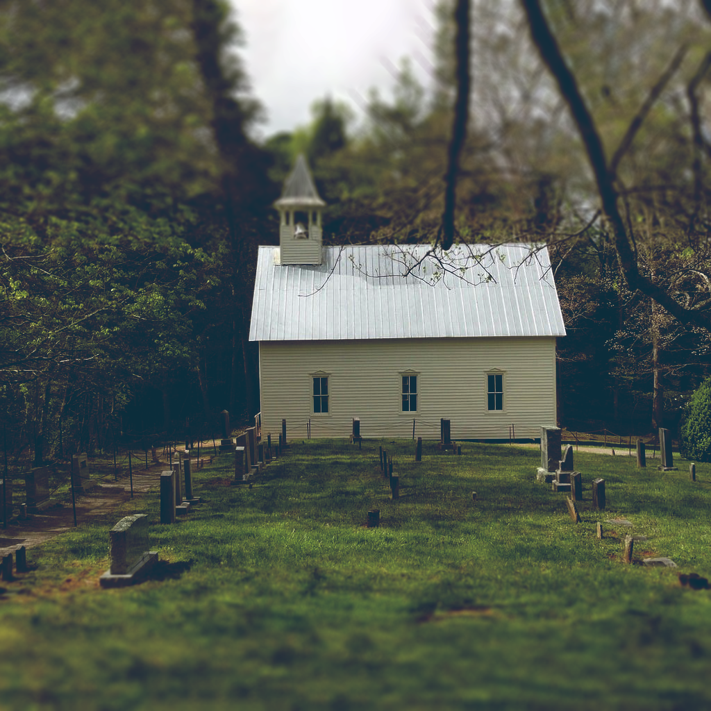 A small church in rural Tennessee, flanked by a small graveyard